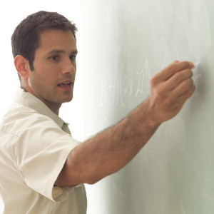 Math Teacher Writing on Chalk Board